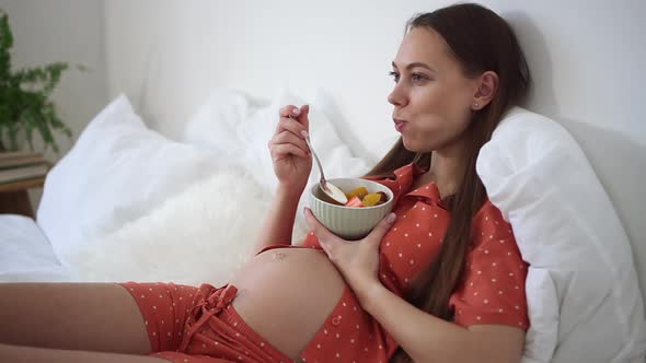 Pregnant Woman Eat Fruit Cut in Salad in Bed Morning Breakfast of Expecting Future Mother Spbd