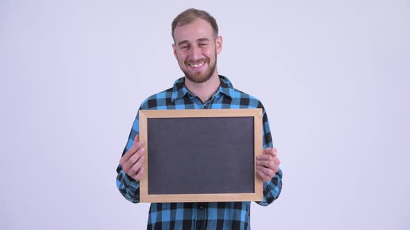 Happy Bearded Hipster Man Talking While Holding Blackboard