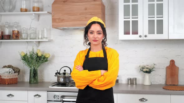 Portrait Serious Housewife Crossing Hands Looking Camera in Home Modern Kitchen