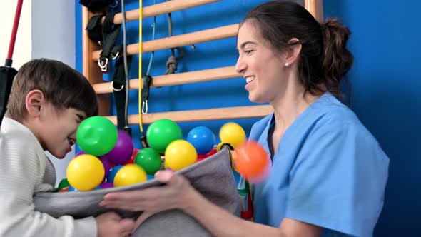 Cute Kid with Cerebral Palsy Doing Musculoskeletal Therapy in the Hospital While Laughing and Having