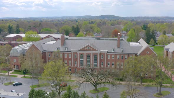 Aerial of large brick Federalist style building on college university campus. Franklin Marshall Coll