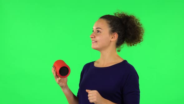 Portrait of Curly Listening To Music with Bluetooth Portable Speaker and Dancing . Green Screen