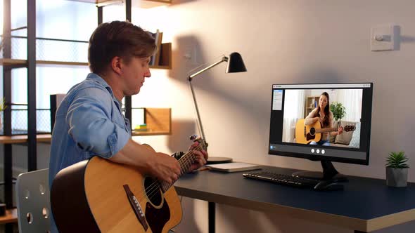 Man Learning To Play Guitar Online at Home