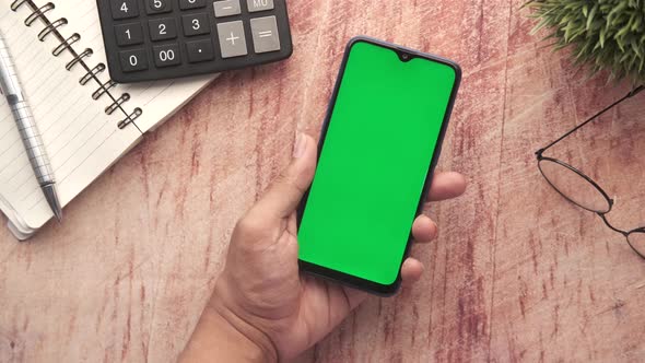 Top View of Man Hand Using Smart Phone on Office Desk