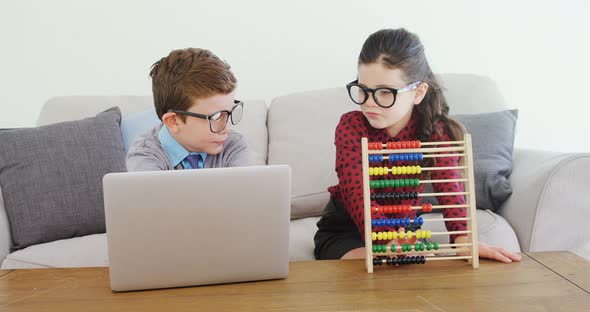 Kids as business executive disusing over laptop 4k