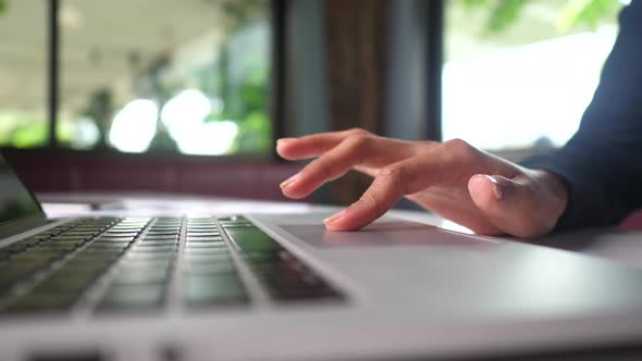 woman's hand uses the trackpad