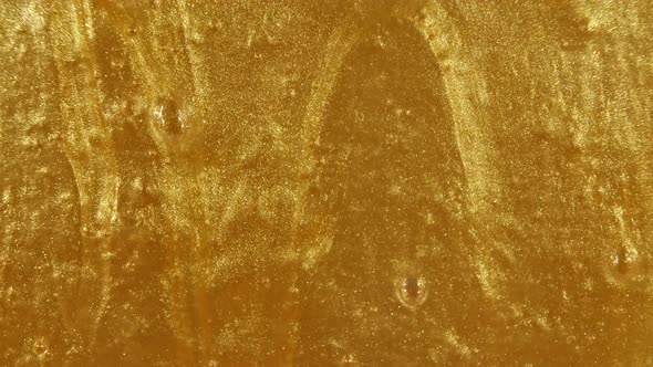 Gold Gel Fluid with Flowing Down on Surface