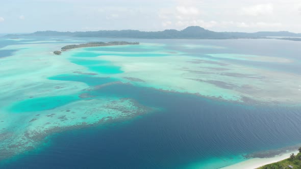 Aerial: flying over tropical island white beach caribbean sea turquoise water co