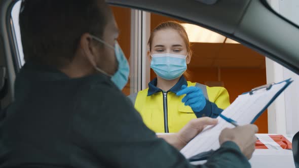 Man Driver in Mask Signing Document on Clipboard Entering Private Area