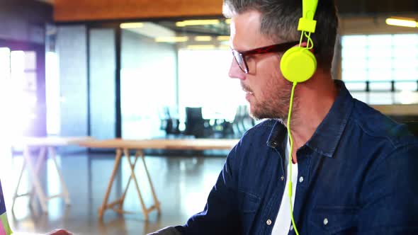 Man listening to music while working on computer