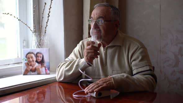 Portrait of Elderly Man with Flu Inhalation at Home