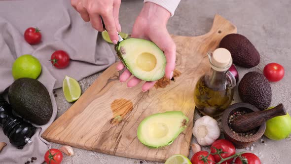 Healthy Vegetarian Food  Woman Peeling Avocado Half with a Spoon