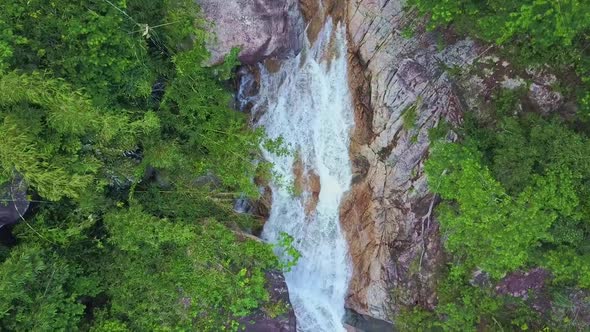 Drone Quickly Approaches River Waterfall Running Into Lake