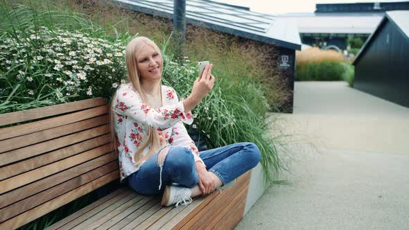 Woman Making Video Call on Green Roof