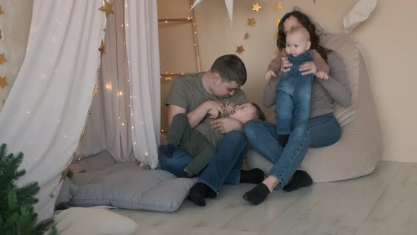 Young Family of Four Playing Together Indoors