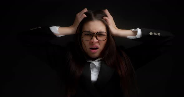 Aggressive Businesswoman Tearing Her Hair on Her Head Black Background
