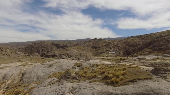 Aerial shot flying over rocky terrain near Mount Champaqui, Cordoba Province, Argentina