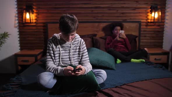 Diverse Teenagers Surfing the Net on Phones Apart