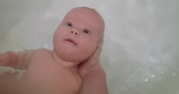 Beautiful Portrait of Newborn Baby During Bathing