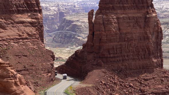 Vehicles traveling through desert canyon