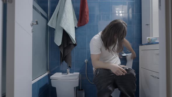 Young Caucasian Man Cleaning Himself After Shit in the Toilet  Frontal Shot