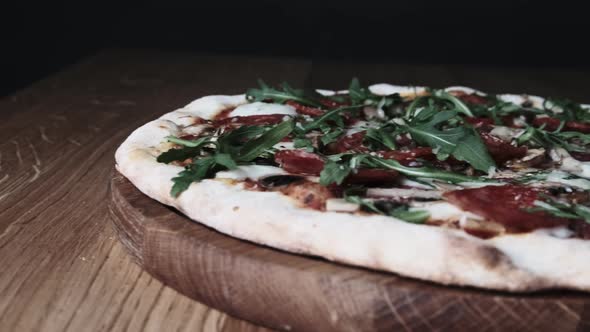 Appetizing Pizza on a Wooden Board in a Restaurant