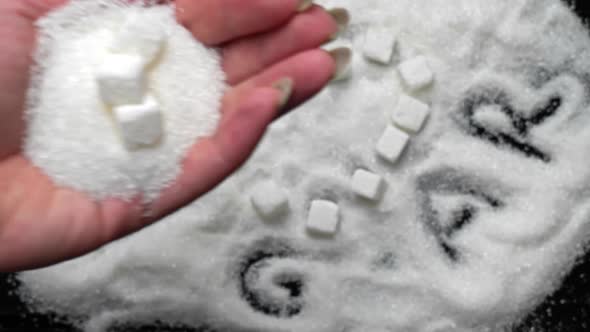 White Sugar Cubes in the Shape of a Heart Lie on Sugar Sand