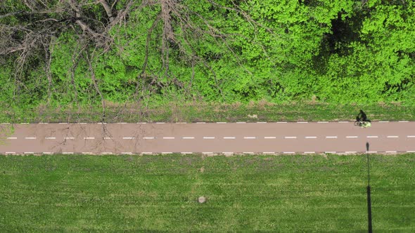 Cyclist Rides Along the Bike