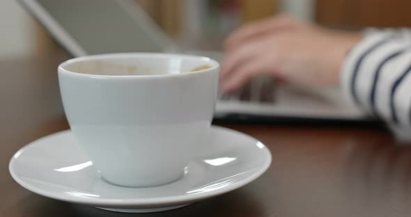 Type of laptop computer, with red lip mark on a coffee cup