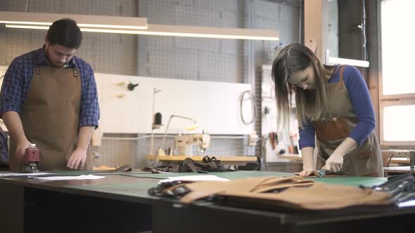 Male and Female Masters Making Bag Details with Artificial Leather