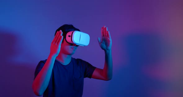 Man Looking Though the VR Device with Red and Blue Light