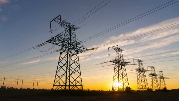 Time lapse - Electricity pylons at sunset. Concept: power, electric, energy, energetics