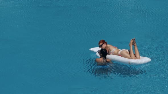 Beautiful Girlfriends Having Fun in Swimming Pool