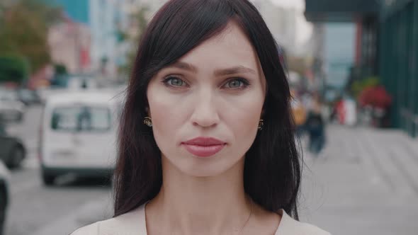 Confident Young Businesswoman Looking at Camera in the City Urban Background