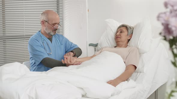 Doctor Measuring Pulse of Female Patient