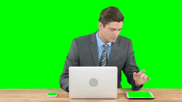 Businessman using laptop and digital tablet