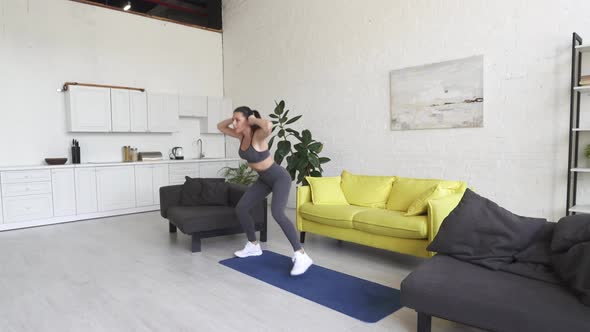 Beautiful Young Woman Doing Fitness at Home