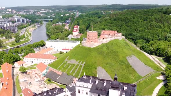 Vilnius cityscape surrounding iconic Gediminas castle, aerial orbit view