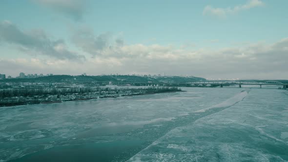 Winter Landscape with a Bridge and a River Overlooking the City of Kyiv