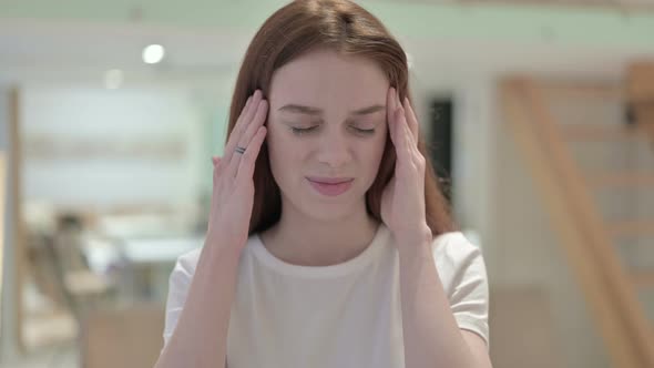 Portrait of Tired Redhead Young Woman Having Headache