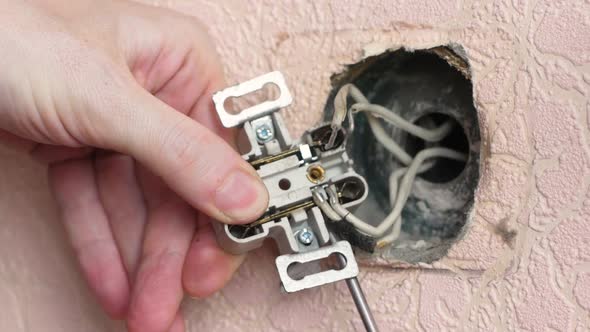 Close-up of replacing an old burnt out electrical outlet.