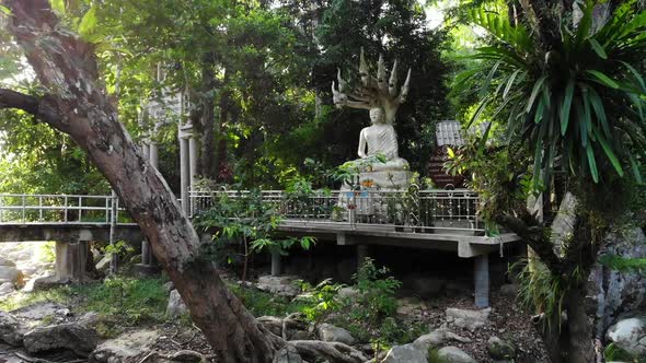 White Buddha Statue Near Temple Near the River Outside of the Traditional Temple in Green Jungle of