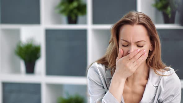 Unhealthy Woman in Pajamas Cough Covering Face By Hands