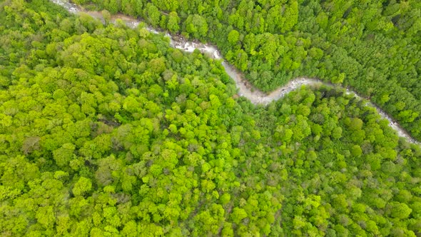 Flying over mountain forest and river