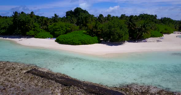 Beautiful fly over clean view of a summer white paradise sand beach and blue ocean background in bes