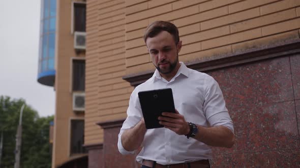 Slow Motion of Young Man Who Hold Black Tablet