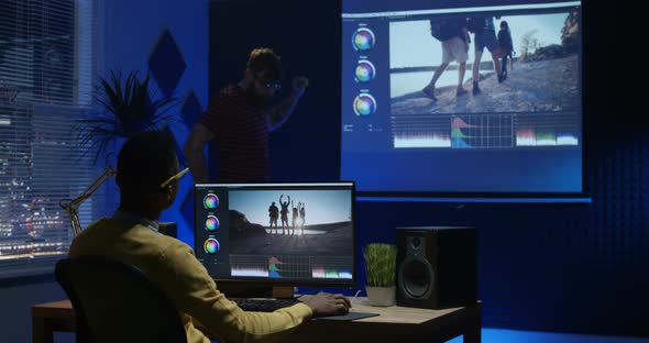 Young Man Editing Video Inside a Room