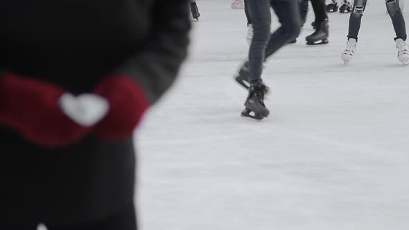 Tourists Skate Close-up on a Large Skating Rink. Feet After Skating Which Skating on a Frozen Lake.