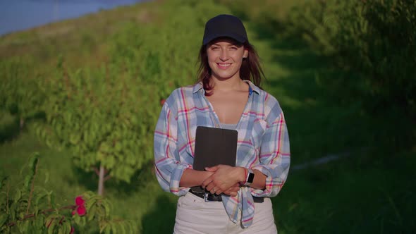 Portrait of Young Woman with Tablet in Fruit Garden Agronomist or Scientist Botanist