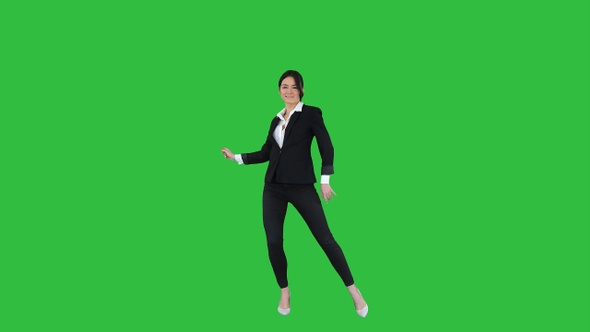 Brunette businesswoman dancing on a Green Screen, Chroma Key